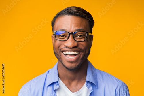 Portrait Of Millennial Afro Guy Smiling To Camera, Studio Shot