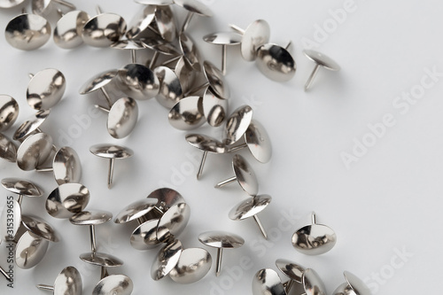Fototapeta Naklejka Na Ścianę i Meble -  drawing pins metal silver on white background