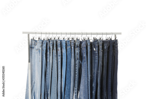 Rack with different jeans isolated on white
