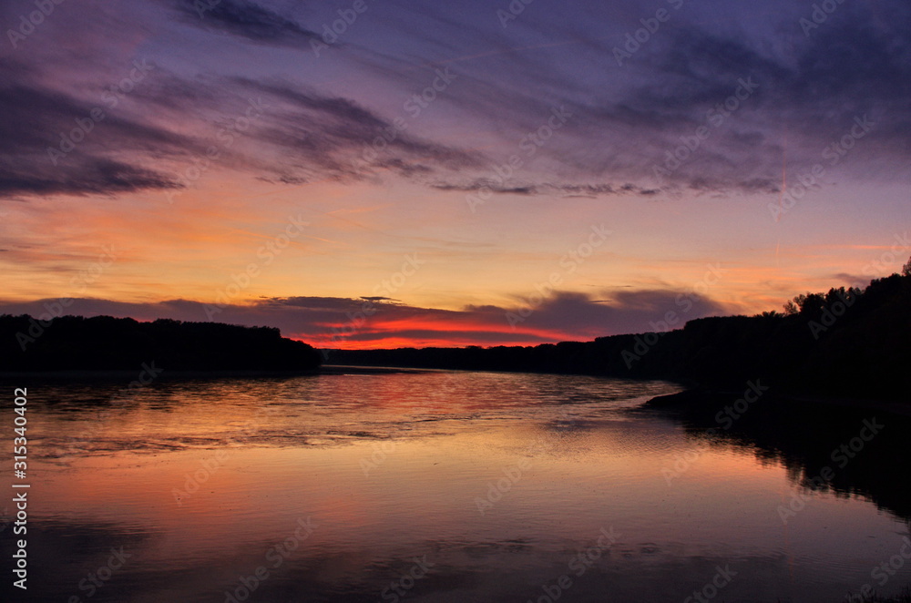 Colorful Sunset At River Side. Beautiful panorama sunset background.