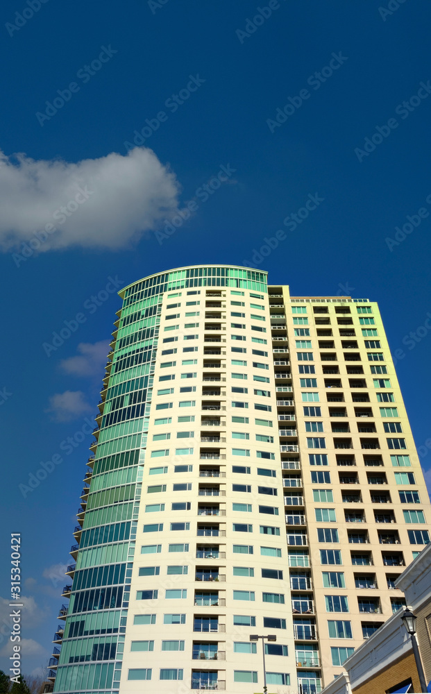 Condo Tower with Green Windows into Blue Sky Condo Tower with Green Windows into Blue Sky