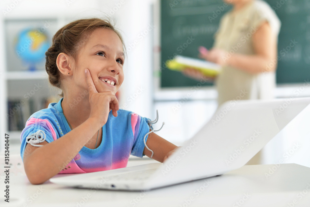 Emotional cute girl using laptop at school Emotional cute girl using laptop at school