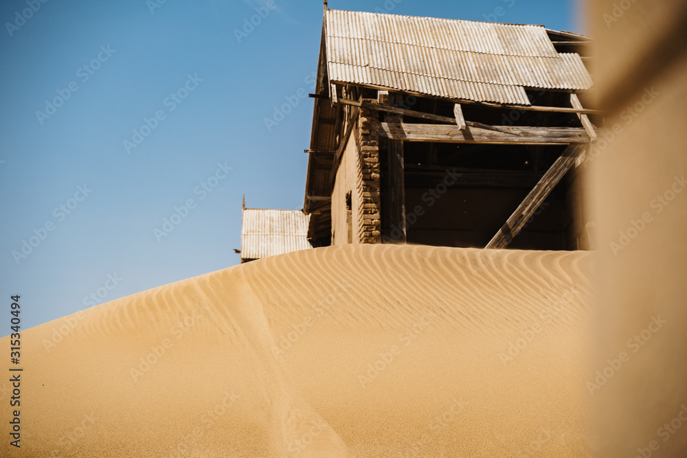 home ruins in the African desert sunk in sand