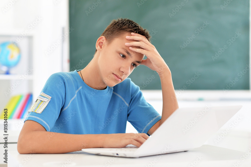 Portrait of boy using laptop in room Portrait of boy using laptop in room