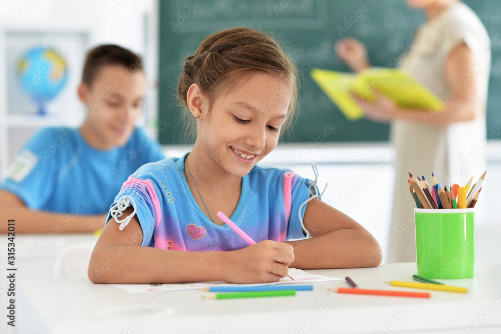 Portrait of little girl drawing at school Portrait of little girl drawing at school