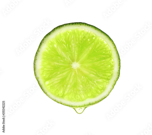 Slice of lime with dripping essential oil isolated on white
