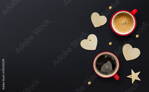 happy valentine's day concept. cup of coffee on black paper background photo