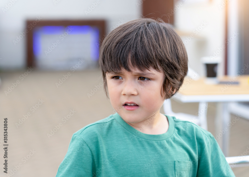 Head shot adorable looking out with curiouse face, Outdoor portrait of cuteboy standing alone, Close up boy face playing outdoor in summer Head shot adorable looking out with curiouse face, Outdoor portrait of cuteboy standing alone, Close up boy face playing outdoor in summer
