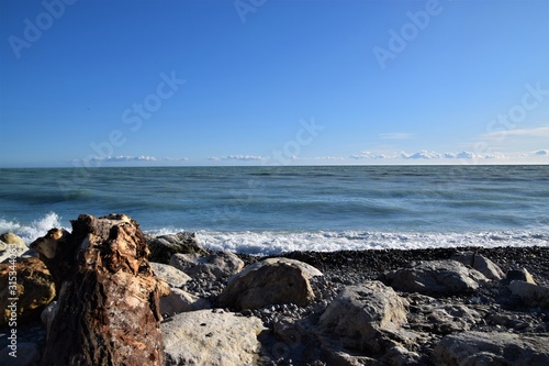 Seaside rocks beach horizon and blue sky nature scene