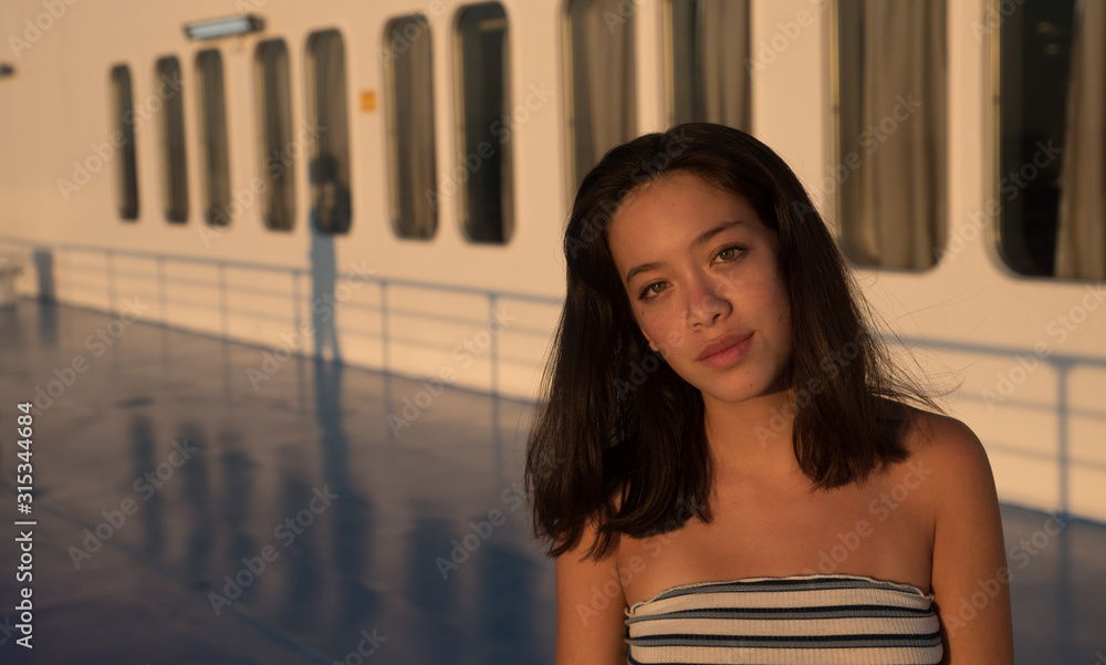 Closeup of Asian teen on in tube top on Ferry boat with windows in the  background Stock Photo | Adobe Stock