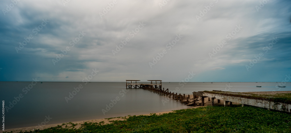 Dilapidated old fishing dock collapsing into the sea in Pak Nam Pran Thailand