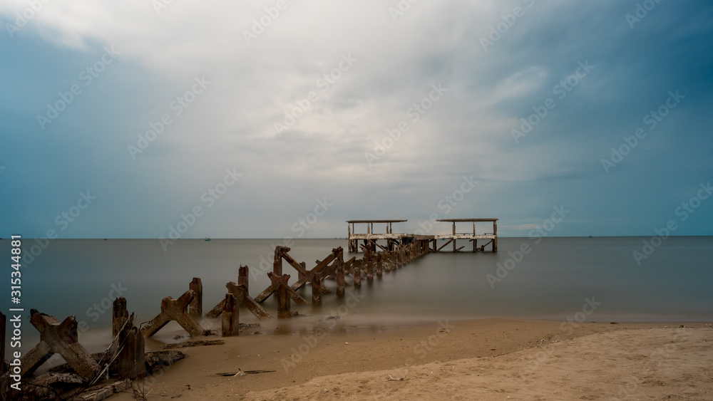 Dilapidated old fishing dock collapsing into the sea in Pak Nam Pran Thailand Dilapidated old fishing dock collapsing into the sea in Pak Nam Pran Thailand