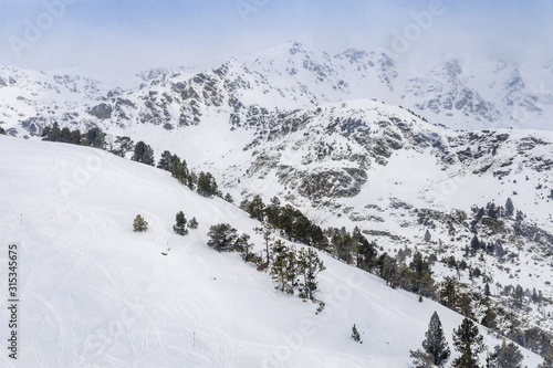 Panorama of winter snow landscape mountain view in Andorra, valley of Pyrenees mountains, South Europe. Andorra is famous tourist travel destination. Luxury amazing resort for skiing and winter rest