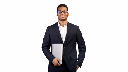 Serious black man holding laptop on white background
