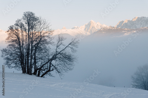 the valley at Sallanches covered with fog on a sunny bright day in the French Mont Blanc massive