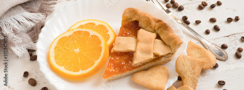 top view slice of pie with orange citrus jam and biscuits photo