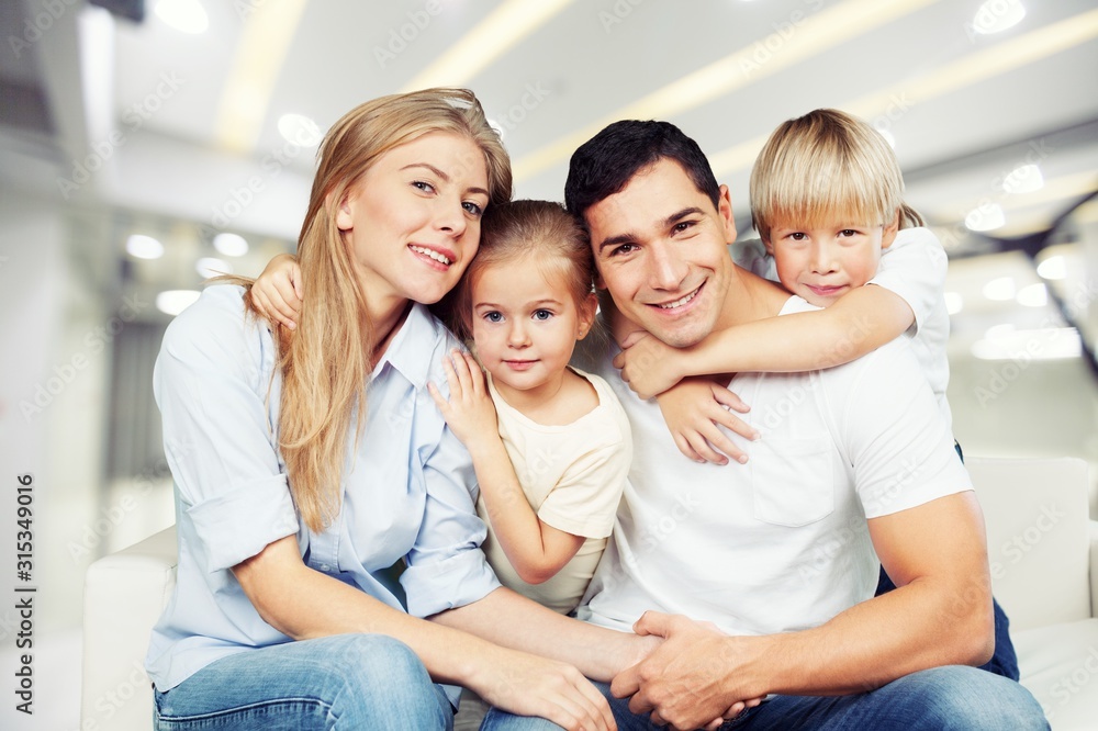 Young family at home smiling at camera Young family at home smiling at camera