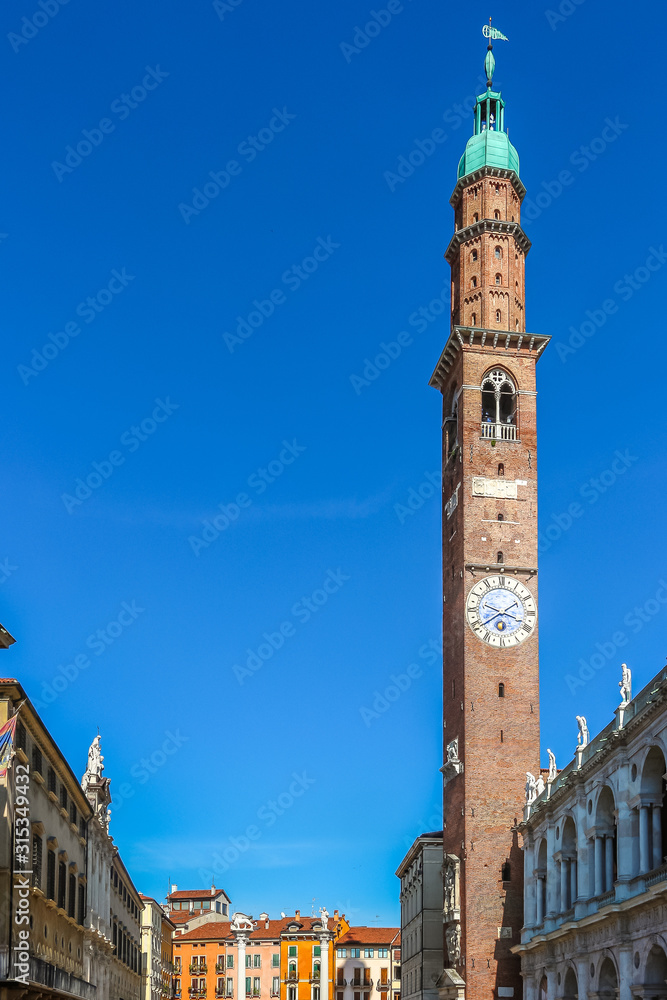 Obraz premium Vicenza, Italy. View of clock tower (Torre Bissara) at famous square (Piazza dei Signori) in Vicenza.
