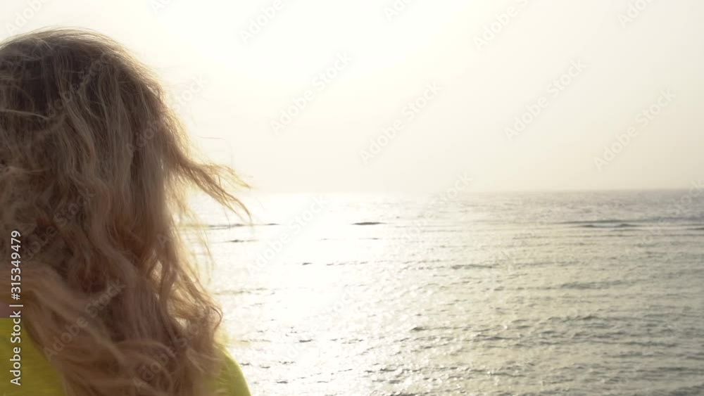 Back view of white woman happy to look at beautiful early morning sea landscape. Full hd video footage. Back view of white woman happy to look at beautiful early morning sea landscape. Full hd video footage.