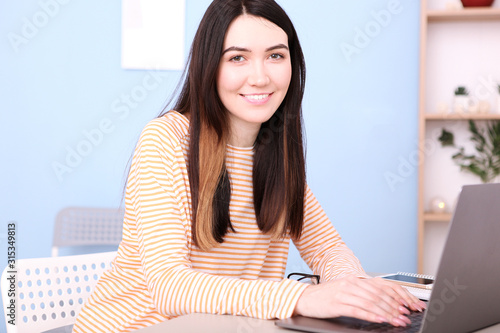 girl works at a laptop at home