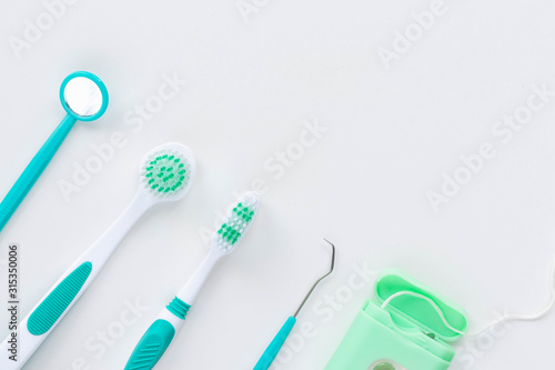 Toothbrushes and hygiene products on a white background. Top view. © Alina Bokhonets