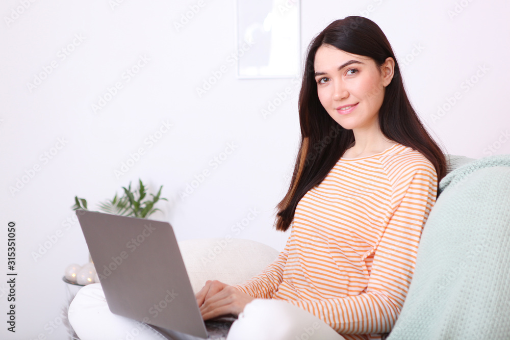 girl works at a laptop at home girl works at a laptop at home