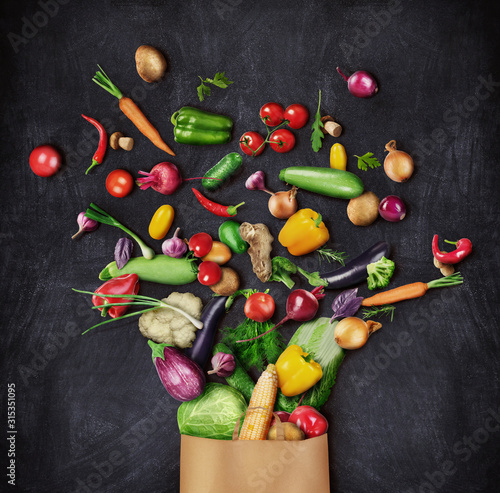 Fototapeta Naklejka Na Ścianę i Meble -  Healthy food is poured from a paper bag on a dark background. Healthy eating concept.