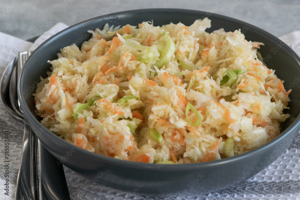 Fresh salad of raw cabbage, leeks and carrots, multivitaminico natural food Fresh salad of raw cabbage, leeks and carrots, multivitaminico natural food