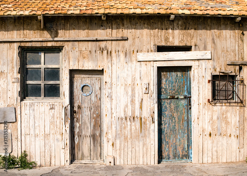 old wooden facade with closed doors