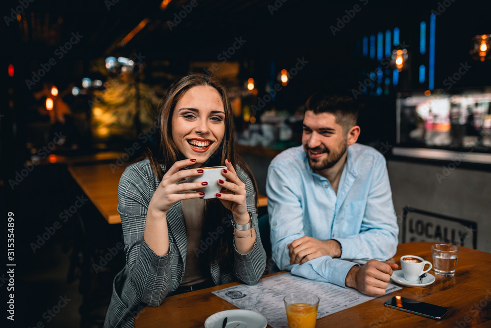 woman holding cup of coffee in restaurant