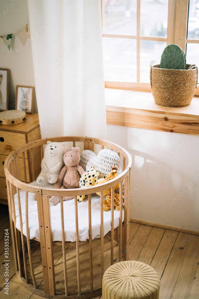 lovely round cot with soft toys inside Stock Photo | Adobe Stock