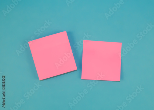 Mock up. Pink stick note on a blue background.
