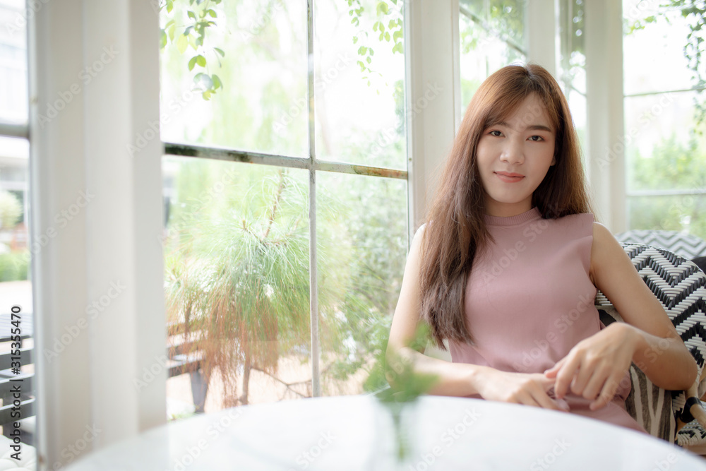 smiling face beautiful asian younger woman relaxing in living room smiling face beautiful asian younger woman relaxing in living room