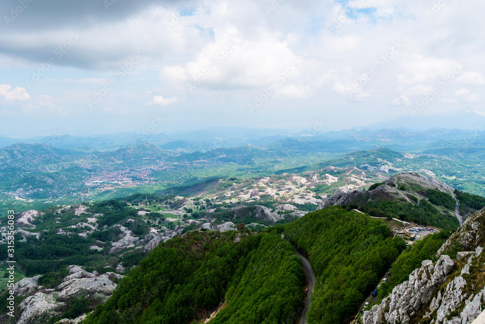 the view of the mountains in Montenegro. mountain ranges in summer in green , blue sky the view of the mountains in Montenegro. mountain ranges in summer in green , blue sky