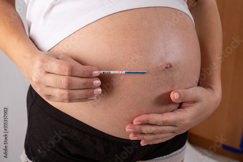 positive pregnancy test in woman hands close up