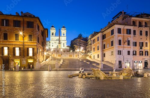 Night view of Spanish Steps and Fontana della Barcaccia in Rome, Italy.