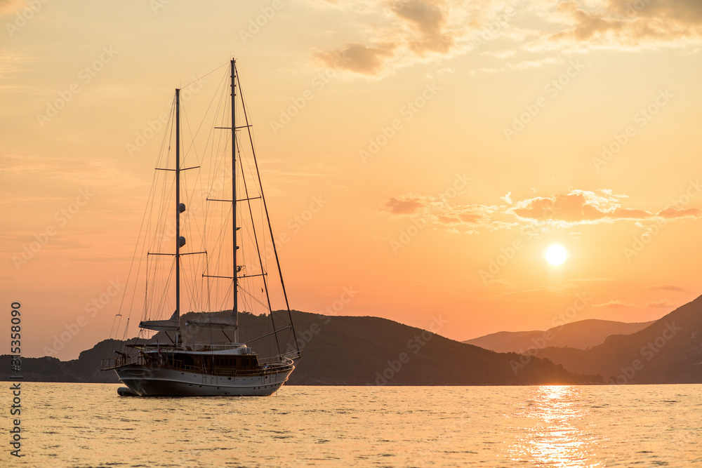 Adriatic sea, coast . in the sea at sunset ship . panoramic views of the sunset. taken at a long shutter speed . summer beach holidays