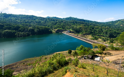 The Kotmale Dam is a irrigation dam in Kotmale, Sri Lanka. The dam generates power from three 67 MW turbines, total making it the second largest hydroelectric power station in Sri Lanka.