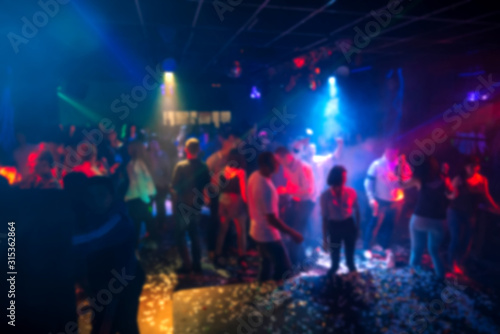Slika na platnu silhouettes of a crowd of people dancing in a nightclub on the dance floor at a