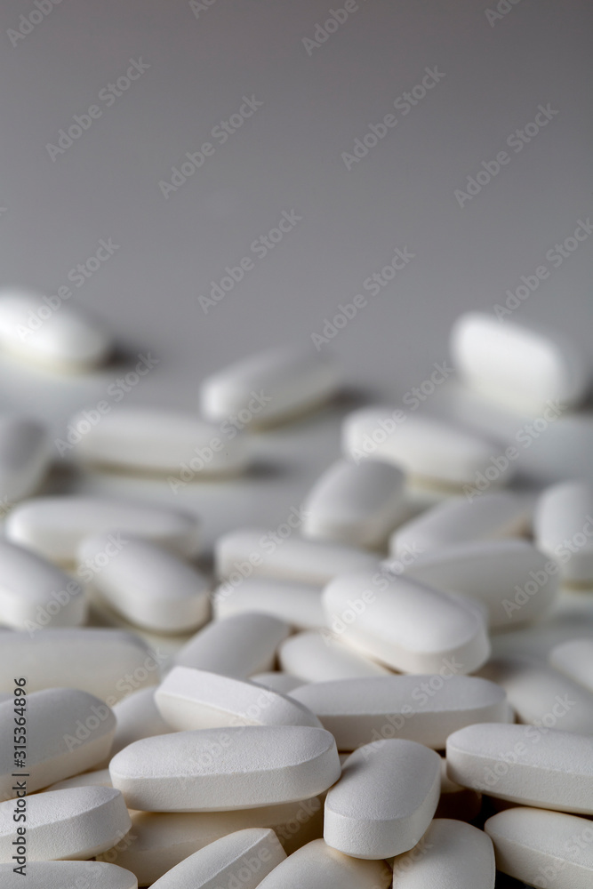 Pills tablets vitamins drugs white close up macro shot Pills tablets vitamins drugs white close up macro shot