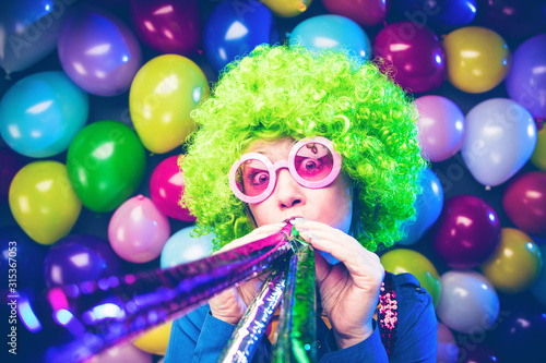 Portrait of beautiful party woman in wig and glasses (Carneval).