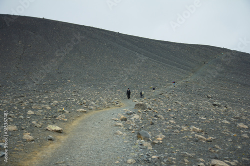 Iceland landscape. Clambering into a volcano, Long path to a scenic crater edge.