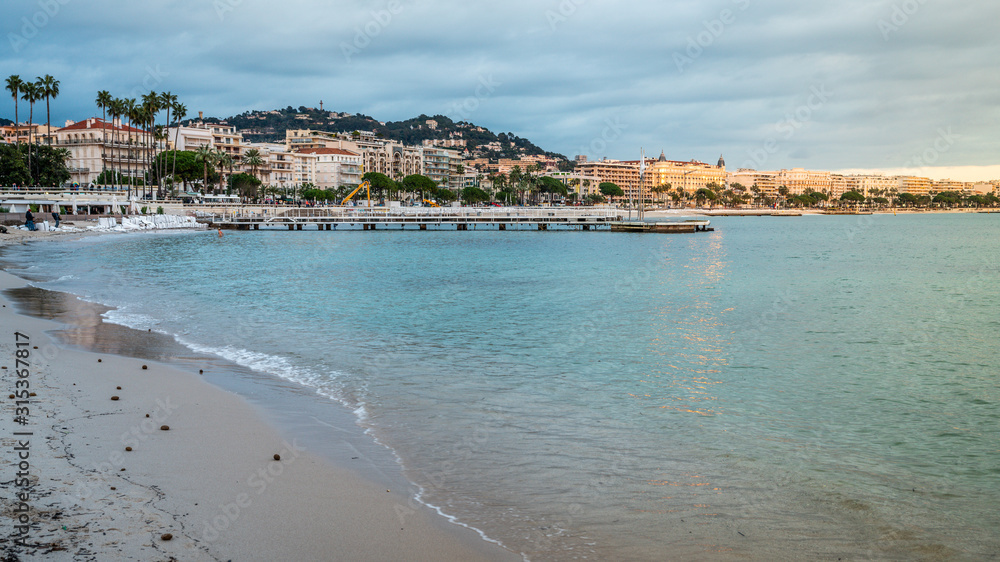 Croisette beach and Cannes cityscape at dusk Cannes France