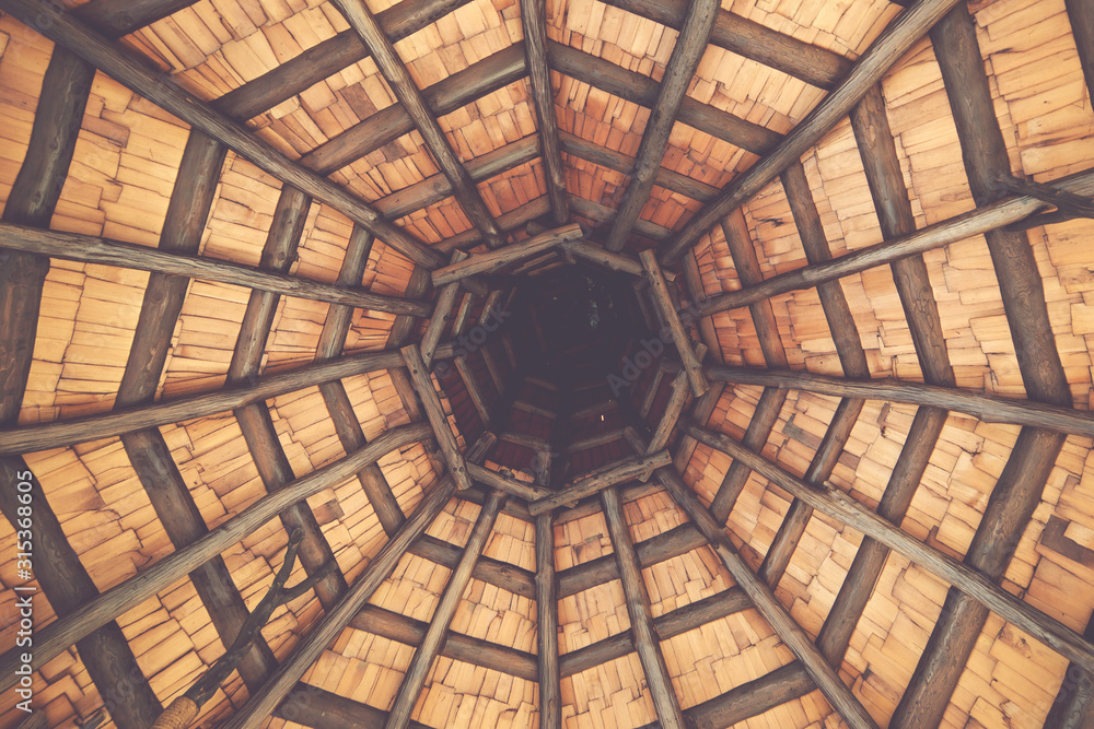 Wooden structure. Interior roof beams in wooden gazebo. Old wooden ceiling. Architectural design of a gazebo