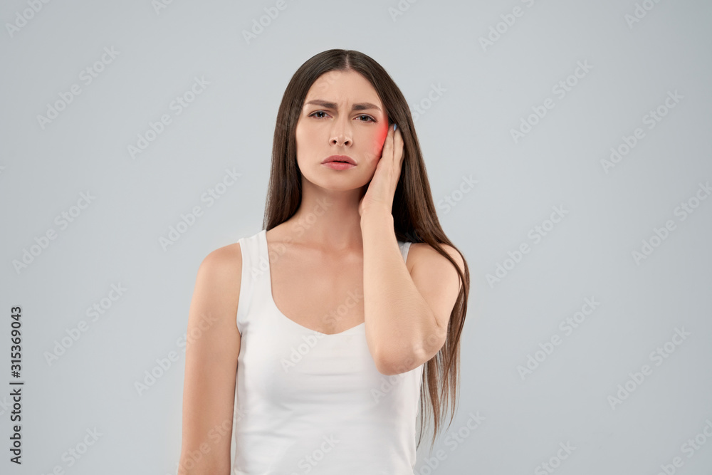 Woman touching head because of earache. Woman touching head because of earache.