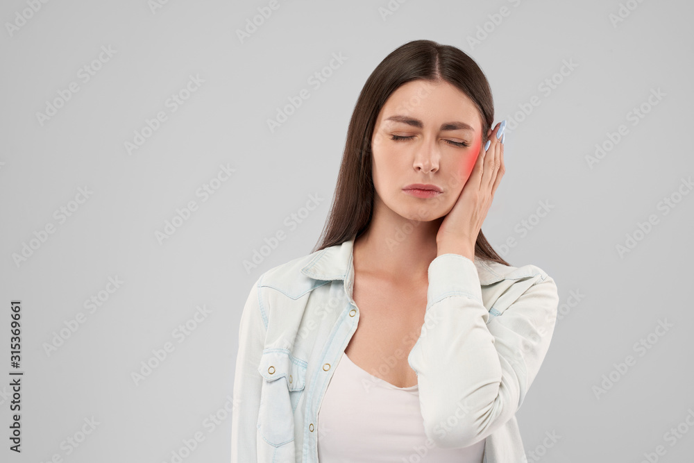 Woman showing earache. Woman showing earache.