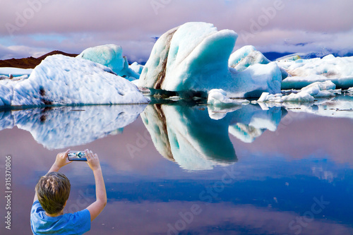  Boy photographs landscape with a smartphone photo