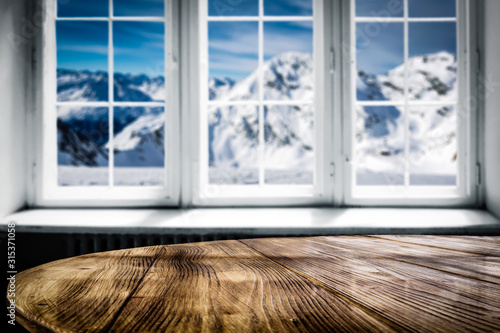 Desk of free space and blurred winter window 