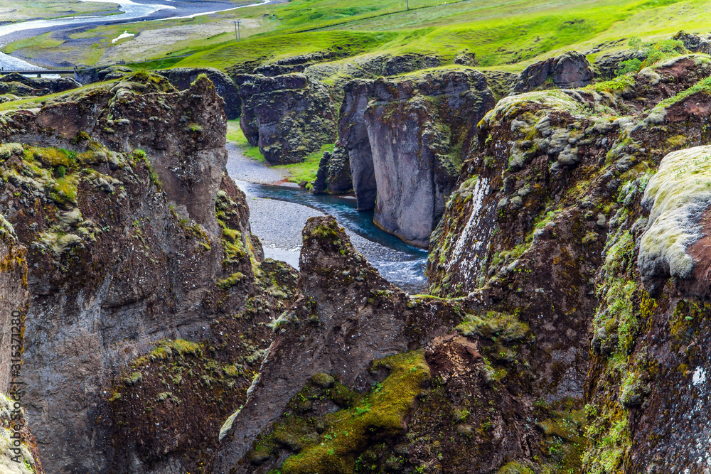 Obraz premium River flows between bizarre cliffs