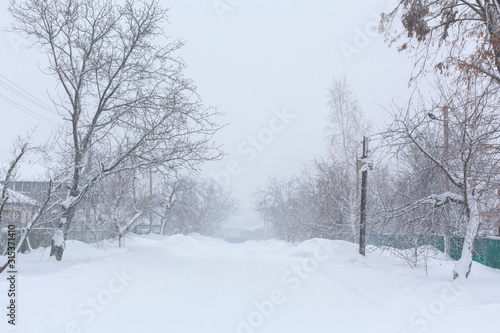 Winter, rural streets are covered with snow. Snow blizzard © Kate
